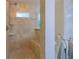 Large tiled walk-in shower with built-in seating, shower head, and decorative glass block window at 13 Count Fleet Dr, Ocala, FL 34482