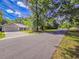 Charming home situated on a quiet street, with a well-manicured lawn and mature trees at 13 Count Fleet Dr, Ocala, FL 34482