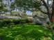Lush backyard with manicured landscaping, mature trees, and green lawn, providing a serene and picturesque outdoor setting at 1308 Timberidge N Loop, Lakeland, FL 33809