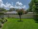 Fenced backyard with well-maintained lawn and tasteful landscaping, offering privacy and a delightful outdoor space at 1308 Timberidge N Loop, Lakeland, FL 33809