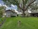 Spacious backyard with a storage shed, mature trees, and a bird bath, creating a serene outdoor oasis at 1308 Timberidge N Loop, Lakeland, FL 33809