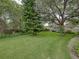 Well-manicured backyard featuring mature trees, manicured landscaping, and a lush green lawn, creating a private retreat at 1308 Timberidge N Loop, Lakeland, FL 33809