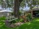 Backyard featuring mature trees, green grass and swing under shade at 1308 Timberidge N Loop, Lakeland, FL 33809