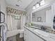 Clean bathroom featuring a tub with shower, vanity with granite countertop, and updated fixtures at 1308 Timberidge N Loop, Lakeland, FL 33809