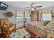 Cozy bedroom featuring colorful decor, hardwood floors, and comfortable seating area at 1308 Timberidge N Loop, Lakeland, FL 33809