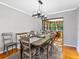 Cozy dining room features modern chandelier and access to living room with a large window at 1308 Timberidge N Loop, Lakeland, FL 33809