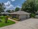 Charming stone accented home with a well-manicured lawn and a paved walkway leading to the front entrance at 1308 Timberidge N Loop, Lakeland, FL 33809