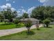 Lovely home with a spacious driveway and blossoming shrubs, enhancing its welcoming exterior at 1308 Timberidge N Loop, Lakeland, FL 33809