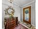 Foyer featuring a decorative mirror above a wooden dresser and a decorative glass front door at 1308 Timberidge N Loop, Lakeland, FL 33809
