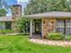 Inviting front entrance features stone accents, manicured landscaping, and a welcoming walkway at 1308 Timberidge N Loop, Lakeland, FL 33809