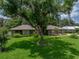 Charming home with well-manicured lawn and mature landscaping, creating an inviting curb appeal at 1308 Timberidge N Loop, Lakeland, FL 33809