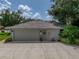 Spacious garage with a well-maintained exterior, showcasing practicality and curb appeal at 1308 Timberidge N Loop, Lakeland, FL 33809