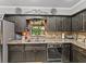 The kitchen offers granite countertops, stainless steel appliances, and wood cabinets at 1308 Timberidge N Loop, Lakeland, FL 33809