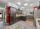 Charming kitchen featuring dark cabinets, granite countertops, and stainless steel appliances at 1308 Timberidge N Loop, Lakeland, FL 33809