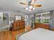Bright main bedroom with hardwood floors, dresser, and ensuite bathroom access at 1308 Timberidge N Loop, Lakeland, FL 33809