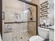 Detailed view of the glass-enclosed shower showcasing tile walls and flooring at 1308 Timberidge N Loop, Lakeland, FL 33809