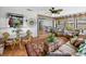 Bright sunroom with glass table, lots of windows, and wicker furniture at 1308 Timberidge N Loop, Lakeland, FL 33809