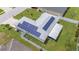 Aerial view of home with solar panels installed on the roof and a screened lanai at 1420 Meadows Pond Dr, Bartow, FL 33830