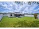 Spacious backyard featuring a screened-in lanai and a well-maintained lawn at 1420 Meadows Pond Dr, Bartow, FL 33830