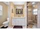 Bathroom with a modern vanity, mirror, and a stylish tiled shower with a glass door at 1420 Meadows Pond Dr, Bartow, FL 33830