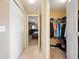 Walk-in closet space with rods and shelves for storage, connecting the bedroom and bathroom at 1420 Meadows Pond Dr, Bartow, FL 33830