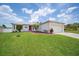 Inviting single-story home featuring a well-manicured lawn, landscaping and an attached two-car garage at 1420 Meadows Pond Dr, Bartow, FL 33830