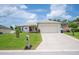 Charming single-story home featuring a well-manicured lawn and attached two-car garage at 1420 Meadows Pond Dr, Bartow, FL 33830