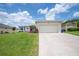 Inviting single-story home featuring a manicured lawn and attached two car garage at 1420 Meadows Pond Dr, Bartow, FL 33830