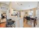 Charming kitchen with white cabinets, stainless steel appliances, and a cozy breakfast bar at 1420 Meadows Pond Dr, Bartow, FL 33830