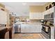 Bright kitchen with stainless steel appliances, light cabinets, and an adjacent dining area at 1420 Meadows Pond Dr, Bartow, FL 33830