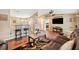 Open-concept living room showcasing wood floors, a breakfast bar, and view into bedroom at 1420 Meadows Pond Dr, Bartow, FL 33830