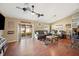 Spacious living room with wood floors, fan and sliding doors to the backyard at 1420 Meadows Pond Dr, Bartow, FL 33830