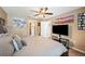 Comfortable main bedroom with a ceiling fan and a TV, decorated with Gathering photos on the wall at 1420 Meadows Pond Dr, Bartow, FL 33830