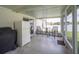 Enclosed patio with screened windows, outdoor seating, and white refrigerator at 1420 Meadows Pond Dr, Bartow, FL 33830