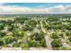 Aerial view showcasing a neighborhood with mature trees and distant lake views at 1604 Park Dr, Lakeland, FL 33803