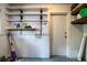 Organized basement area with wall shelving and cleaning supplies at 1604 Park Dr, Lakeland, FL 33803
