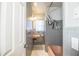 Cozy bathroom with a pink sink and bathtub, gray tile, and white accents, offering a vintage aesthetic at 1604 Park Dr, Lakeland, FL 33803