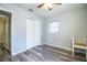 Cozy bedroom with wood-look flooring, ceiling fan, and closet at 1604 Park Dr, Lakeland, FL 33803
