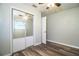 This bedroom has updated flooring, a ceiling fan and closet with mirrored sliding doors at 1604 Park Dr, Lakeland, FL 33803