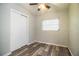 Bedroom featuring ceiling fan, wood-look floors, and closet at 1604 Park Dr, Lakeland, FL 33803
