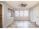 Bright dining room area with tile floor, three sunny windows, and back door at 1604 Park Dr, Lakeland, FL 33803