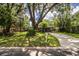 Attractive one-story home with a long driveway, lovely lawn, and gorgeous, mature shade trees in the front yard at 1604 Park Dr, Lakeland, FL 33803
