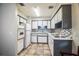 Functional kitchen featuring white cabinets, tile floor, and stainless sink at 1604 Park Dr, Lakeland, FL 33803