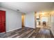 Inviting living room featuring wood-look floors and a bright red front door at 1604 Park Dr, Lakeland, FL 33803