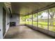 Enclosed back porch with screen panels and a concrete floor overlooking the backyard at 1604 Park Dr, Lakeland, FL 33803