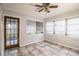 Bright sun room with tile floors, ceiling fan, and lots of windows at 1604 Park Dr, Lakeland, FL 33803