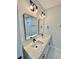 Modern bathroom featuring double sinks, quartz counters, updated fixtures, and framed mirrors at 1683 Sw 3Rd St, Ocala, FL 34471