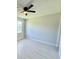 Bright bedroom with luxury vinyl plank flooring and a window overlooking the yard at 1683 Sw 3Rd St, Ocala, FL 34471