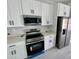 Contemporary kitchen features stainless appliances and white cabinets at 1683 Sw 3Rd St, Ocala, FL 34471