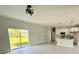 Bright, open-concept living space with sliding glass doors and a modern kitchen at 1683 Sw 3Rd St, Ocala, FL 34471